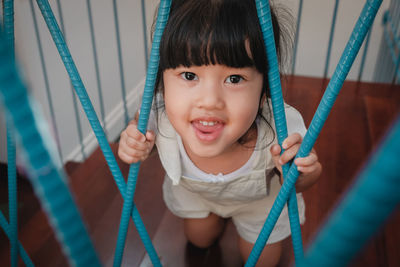 Portrait of cute girl on swing at playground