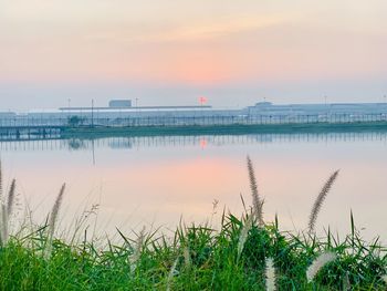 Scenic view of lake against sky during sunset