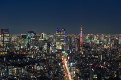 Illuminated cityscape against sky at night