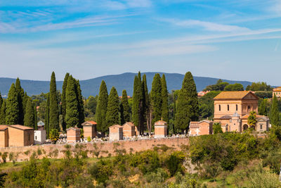 Panoramic view of trees and buildings against sky