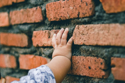 Close-up of human hand on wall