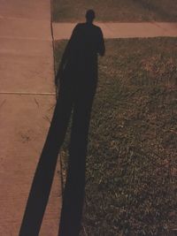 Shadow of man on footpath