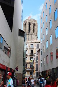 People on street amidst buildings in city