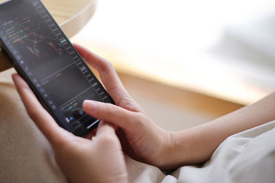 Midsection of woman using mobile phone