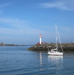 Sailboat in sea against sky