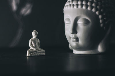 Close-up of buddha statue on table