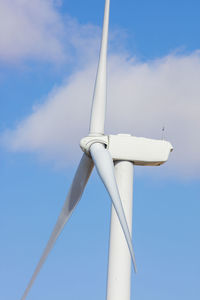 Wind turbine in a field with blue sky