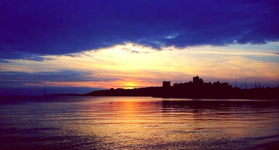 sunset, silhouette, water, sky, waterfront, scenics, reflection, orange color, beauty in nature, building exterior, tranquil scene, built structure, architecture, tranquility, sea, cloud - sky, idyllic, nature, cloud, sun