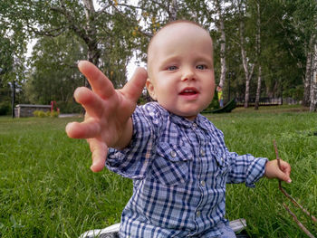 Portrait of cute baby girl on field