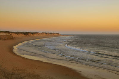 Scenic view of beach against sky during sunset