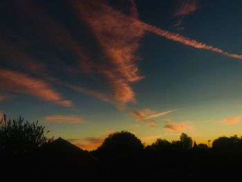 Low angle view of silhouette trees against sky during sunset