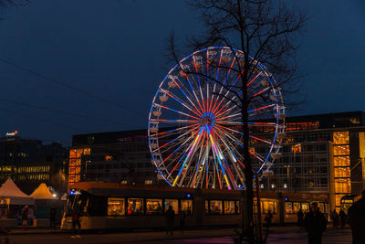 Illuminated ferris wheel at night