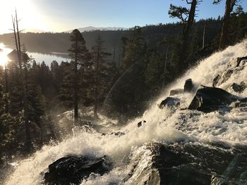 Scenic view of waterfall against sky