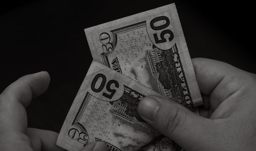 Cropped hand holding paper currency