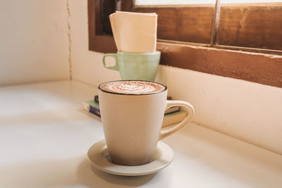 Close-up of coffee cup on table