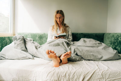 Young woman sleeping on bed at home