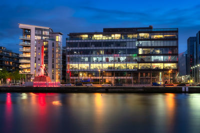 Diving bell modern offices and apartment building on sir john rogerson quay and blurred liffey river