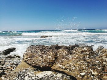 Scenic view of sea against clear blue sky