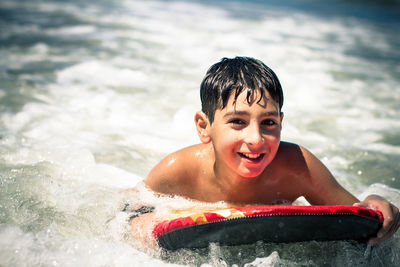 Portrait of boy bodysurfing in sea