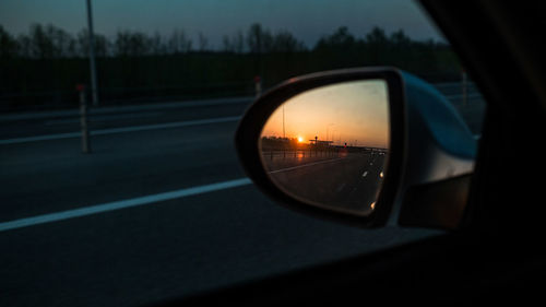 Reflection of car on side-view mirror