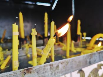 Close-up of lit candles on temple