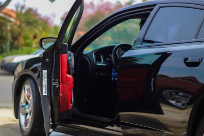 Car with open door in parking lot