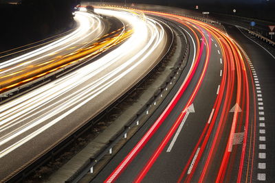High angle view of light trails on highway at night