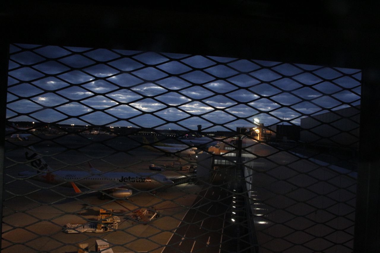 HIGH ANGLE VIEW OF ILLUMINATED CHAINLINK FENCE