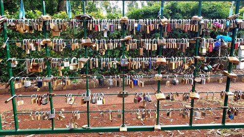Row of water hanging from metal fence
