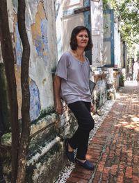 Senior woman standing by wall