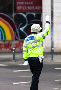 Rear view of man standing on road