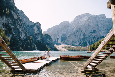 Scenic view of lake and mountains against clear sky