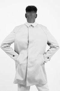 Rear view of man wearing jacket against white background