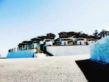 Built structure on beach against clear sky