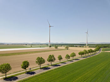 Windmill on field against sky