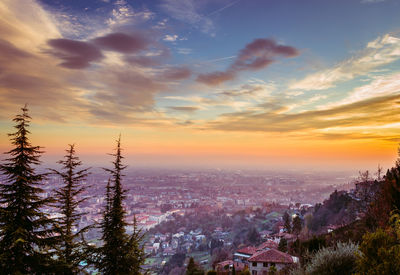 Aerial view of cityscape against sky during sunset