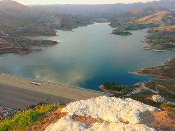 High angle view of river amidst mountains against sky