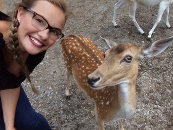 Portrait of smiling young woman with deer