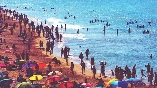 People at beach on sunny day