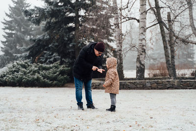 Father playing with child outdoors. happy parenting, family bond