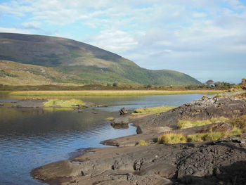 Scenic view of lake and mountains against sky