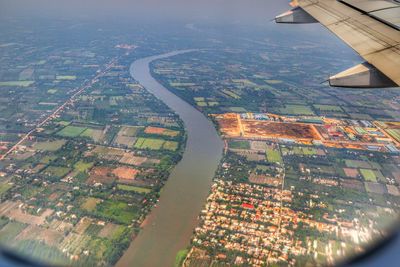 River amidst landscape seen through airplane window