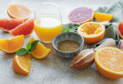 Glass of juice and fresh citrus fruits