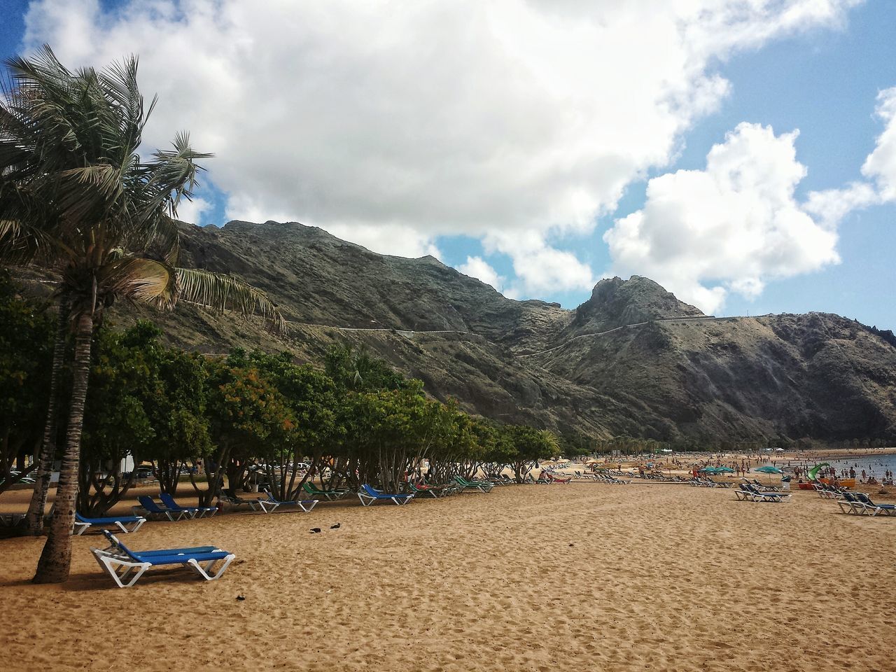 mountain, sky, water, tree, scenics, tranquil scene, beach, tranquility, cloud - sky, mountain range, beauty in nature, vacations, nature, sand, cloud, shore, sea, incidental people, nautical vessel