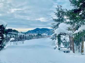 Scenic view of snow covered mountains against sky