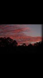 Scenic view of silhouette landscape against sky at sunset