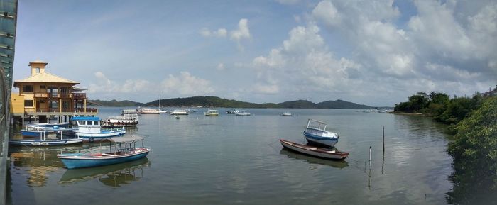 Boats moored in sea against sky