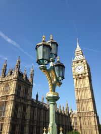 Low angle view of clock tower against blue sky