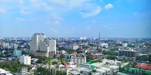 High angle view of modern buildings in city against sky