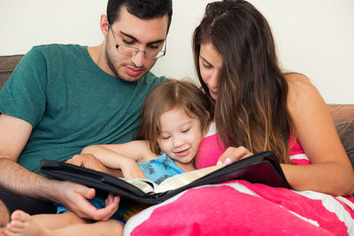 Portrait of father and girl using mobile phone